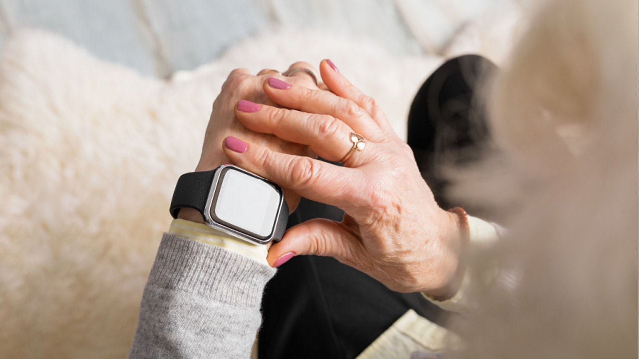 senior woman using smart watch outdoors