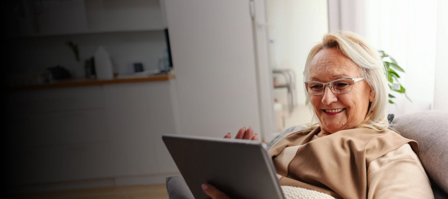 smiling senior woman using a tablet