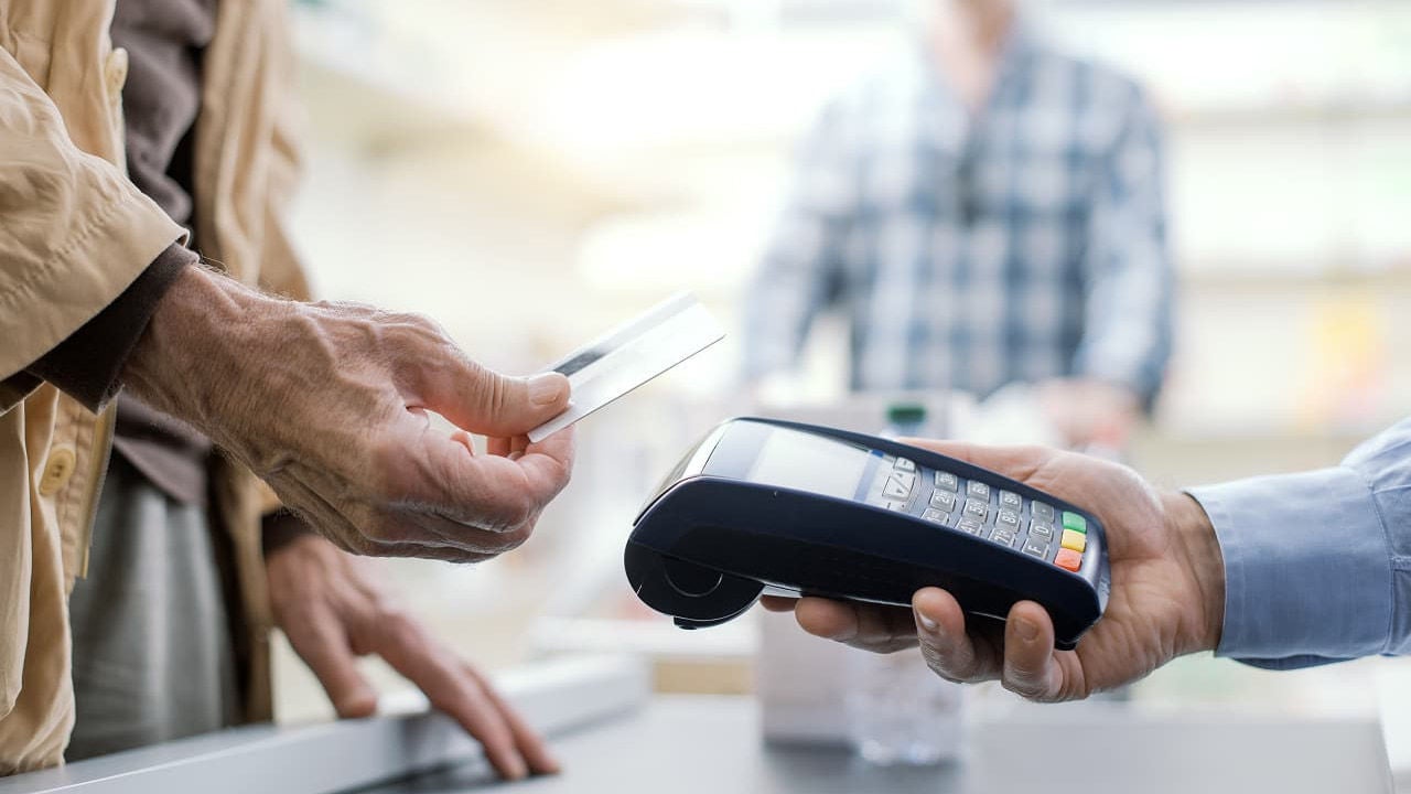 senior making contactless payment