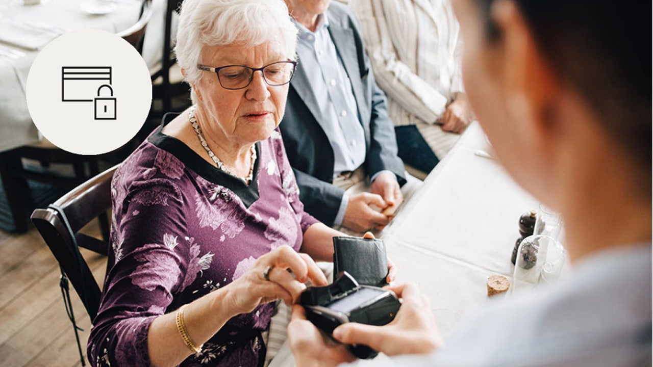 woman paying by card at cafe