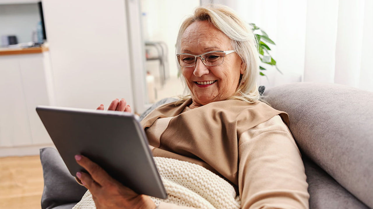 smiling senior woman using a tablet